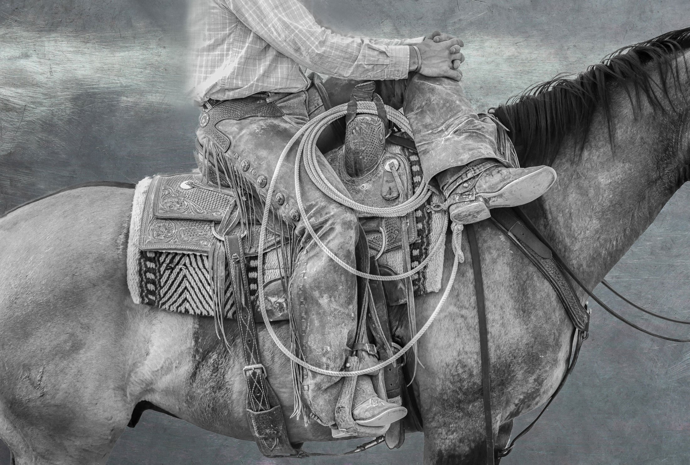 Cowgirl overlooking scenic mountain view on horseback