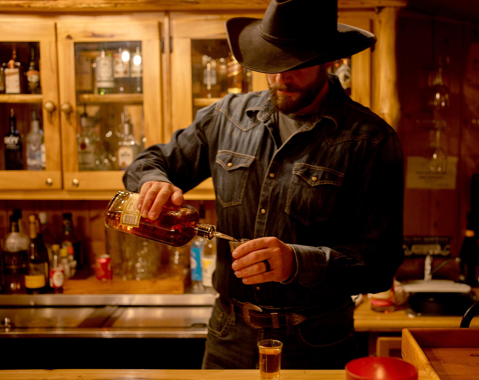 Cowboy Bartender Pouring Burbon